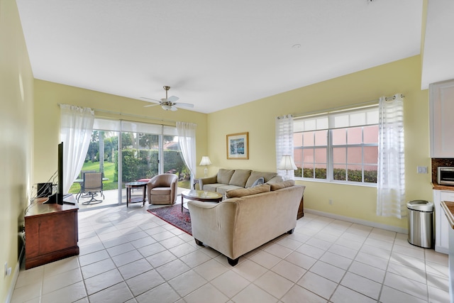 tiled living room with ceiling fan and plenty of natural light