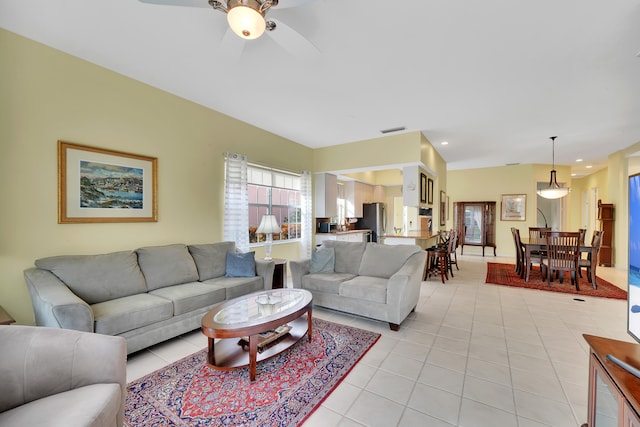 living room featuring light tile patterned floors and ceiling fan