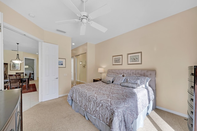 bedroom with light carpet, a closet, and ceiling fan