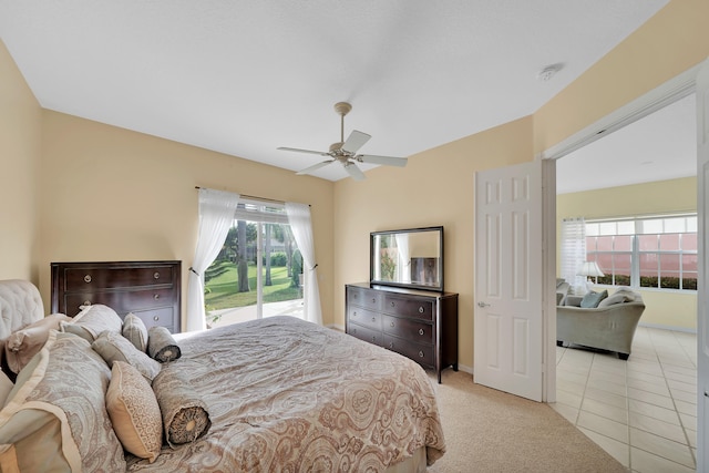 tiled bedroom featuring ceiling fan and access to outside