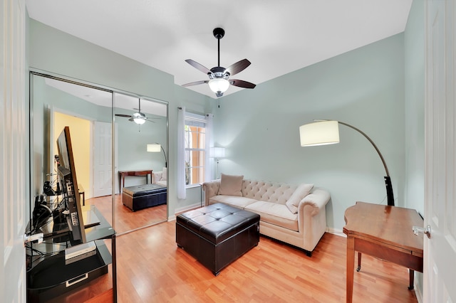 living room with light wood-type flooring and ceiling fan