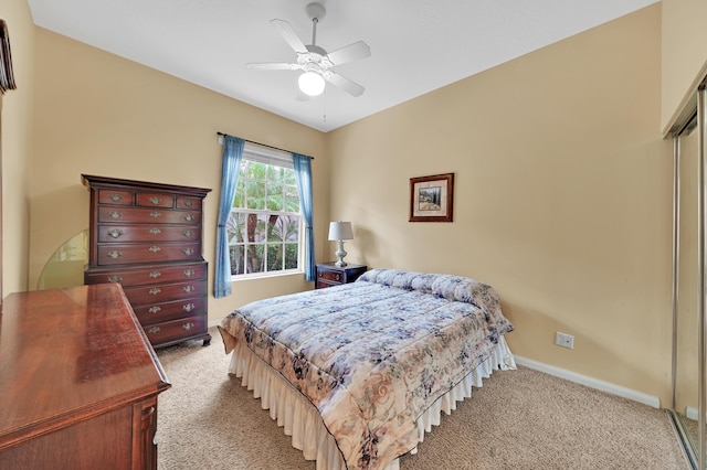 carpeted bedroom featuring a closet and ceiling fan