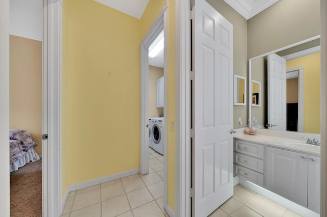 bathroom with vanity, tile patterned floors, crown molding, and washing machine and clothes dryer