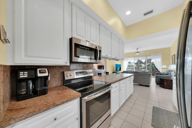 kitchen featuring white cabinetry, light tile patterned floors, and stainless steel appliances