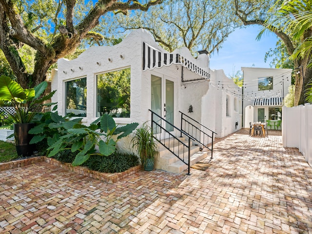 view of side of property with a patio area