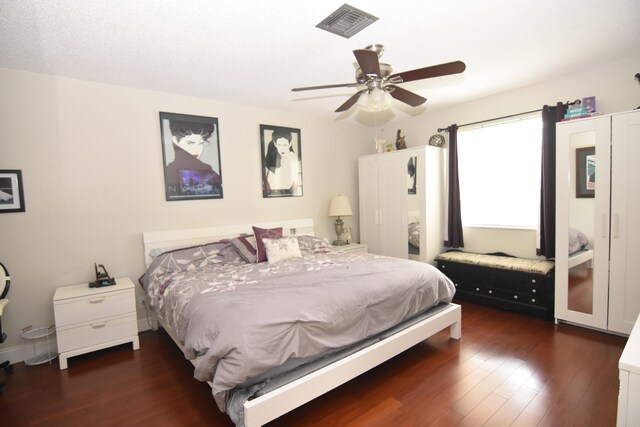 bedroom with ceiling fan and dark hardwood / wood-style floors