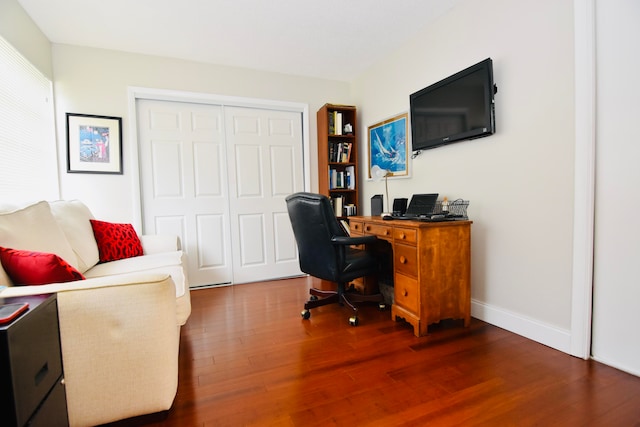 home office with dark hardwood / wood-style floors