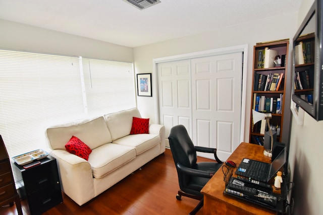 home office with dark wood-type flooring