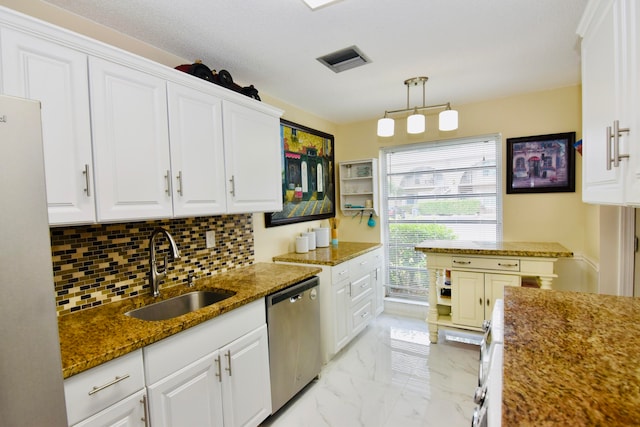 kitchen with white cabinetry, sink, stainless steel dishwasher, and decorative light fixtures