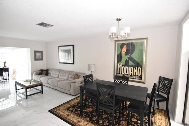 dining area featuring a notable chandelier