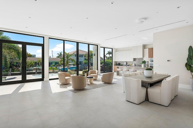 dining area featuring french doors, floor to ceiling windows, and sink