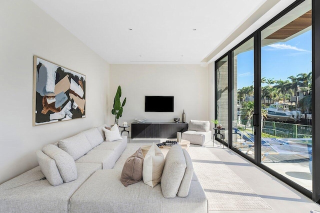 living room featuring floor to ceiling windows and a healthy amount of sunlight