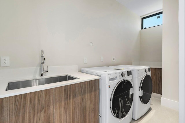 clothes washing area with washer and clothes dryer and sink