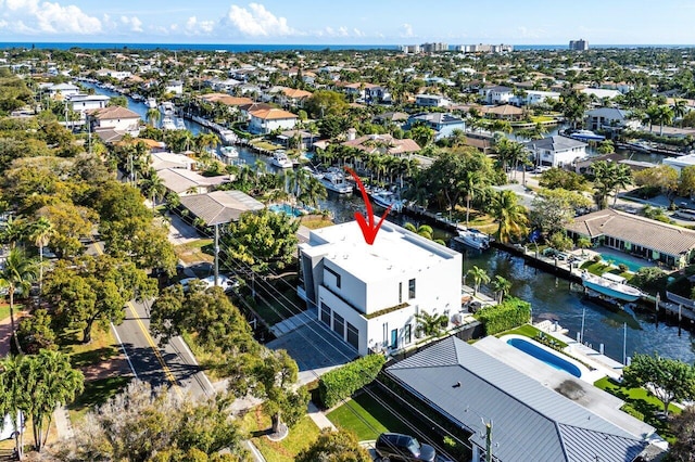 birds eye view of property with a water view