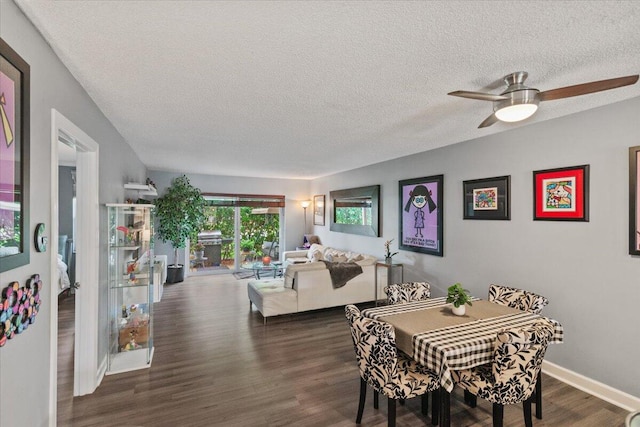 dining room featuring ceiling fan, dark hardwood / wood-style flooring, and a textured ceiling