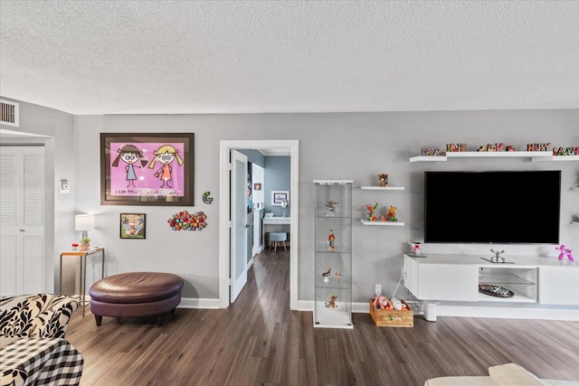 living room featuring hardwood / wood-style floors and a textured ceiling