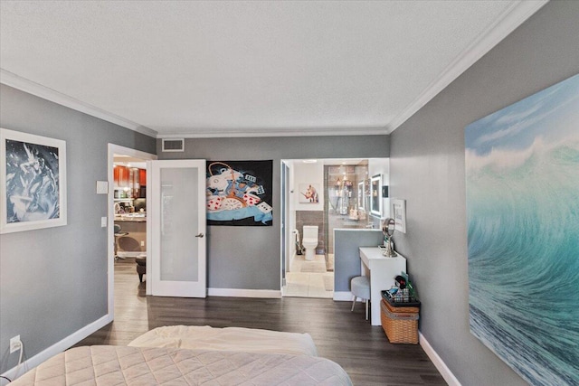 bedroom with a textured ceiling, dark hardwood / wood-style floors, ensuite bathroom, and crown molding