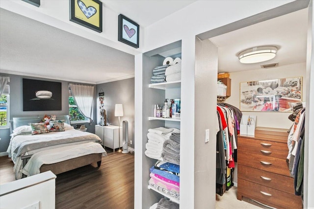 bedroom featuring wood-type flooring and ornamental molding