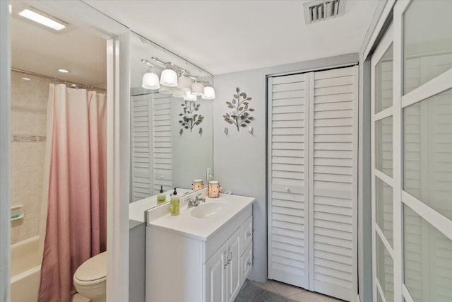 full bathroom with tile patterned floors, vanity, shower / tub combo, and toilet