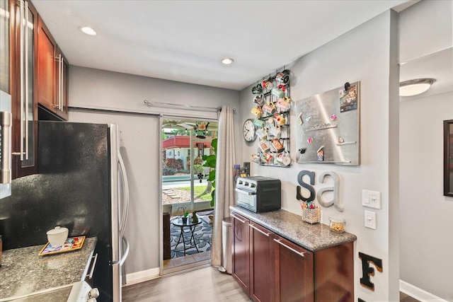 kitchen featuring light hardwood / wood-style floors and stainless steel refrigerator