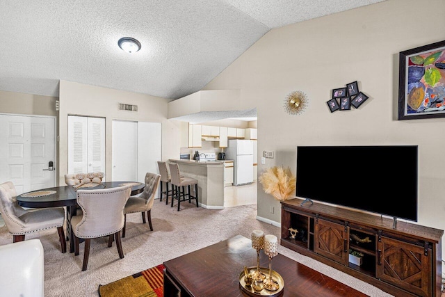 living room with carpet floors and vaulted ceiling