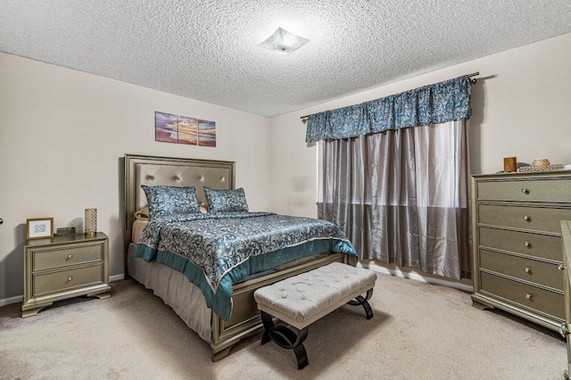 bedroom with a textured ceiling and light carpet