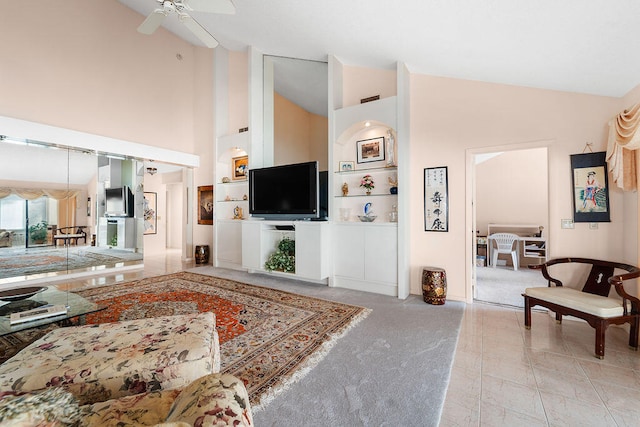 carpeted living room featuring high vaulted ceiling and ceiling fan