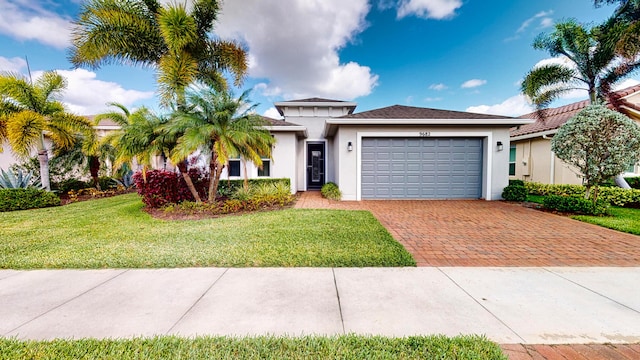 view of front facade with a garage and a front lawn