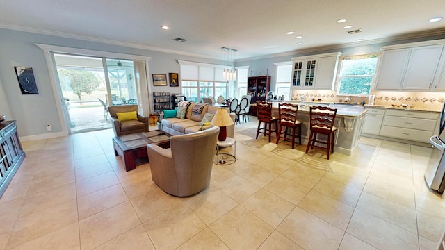 living room with crown molding and light tile patterned floors