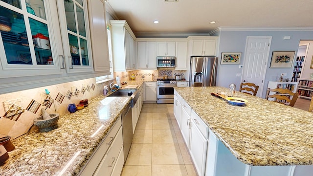 kitchen featuring white cabinetry, appliances with stainless steel finishes, and a center island with sink