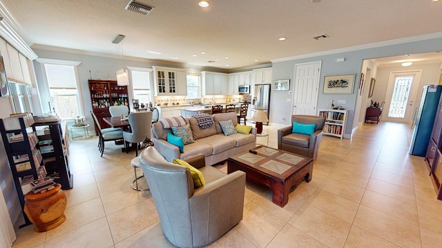 living room featuring crown molding and light tile patterned flooring