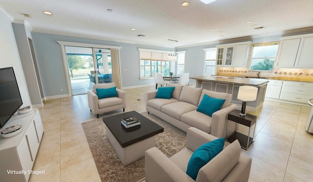 living room featuring crown molding, sink, and light tile patterned floors