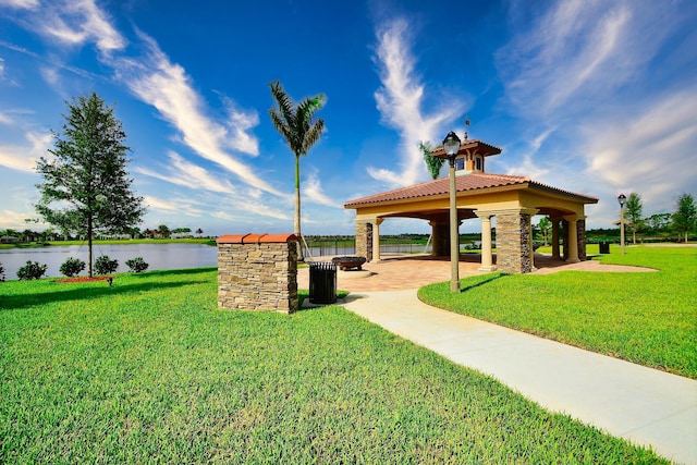 view of home's community featuring a gazebo, a patio area, a lawn, and a water view