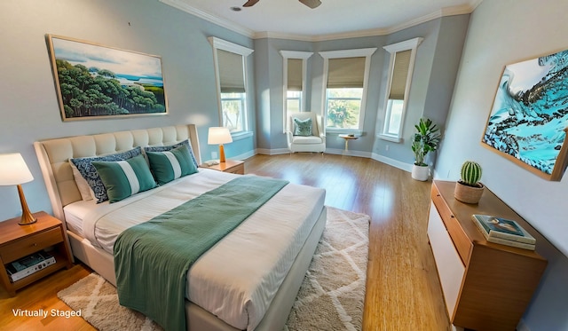 bedroom with ornamental molding, ceiling fan, and light wood-type flooring