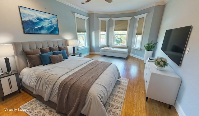 bedroom with ornamental molding, light wood-type flooring, and ceiling fan