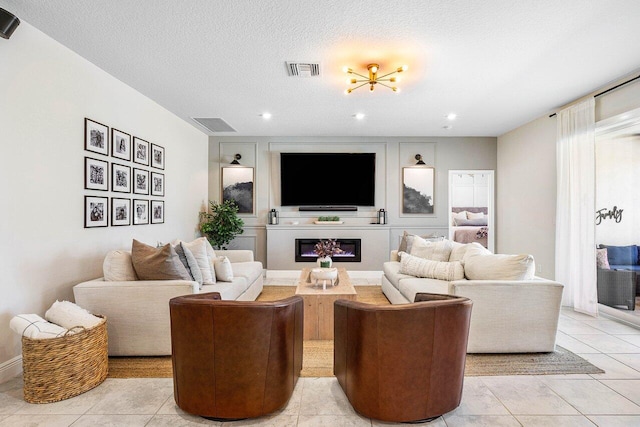 tiled living room featuring a textured ceiling