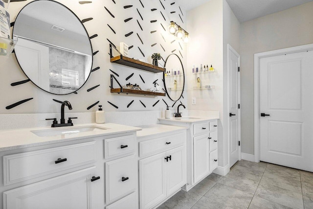 bathroom featuring tile patterned flooring and vanity