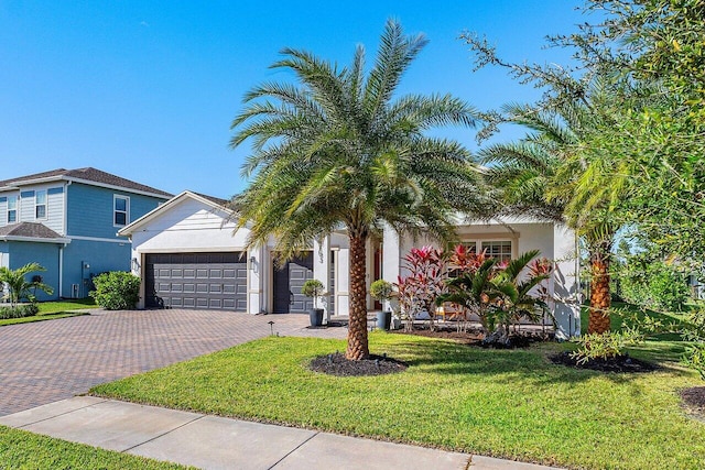 view of front of home with a garage and a front lawn