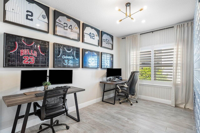 home office featuring a chandelier, wood-type flooring, and a textured ceiling