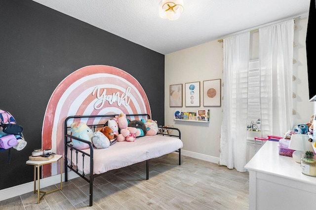 bedroom featuring a textured ceiling and light wood-type flooring