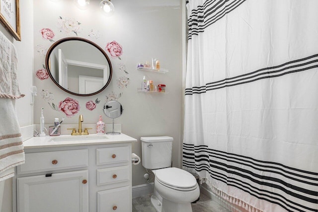 bathroom with vanity, curtained shower, and toilet