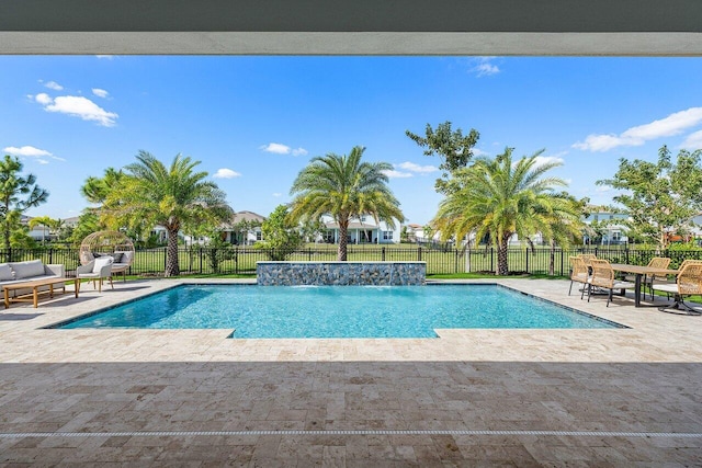 view of swimming pool featuring pool water feature and a patio area