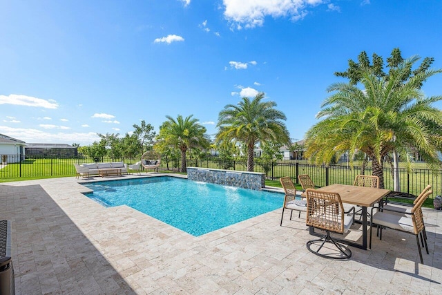 view of swimming pool with pool water feature, an outdoor living space, and a patio