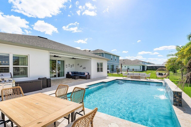 view of swimming pool featuring pool water feature, ceiling fan, a patio area, and an outdoor hangout area