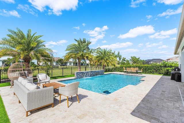 view of pool featuring pool water feature, a patio area, and outdoor lounge area