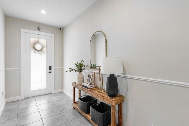 tiled foyer with a textured ceiling