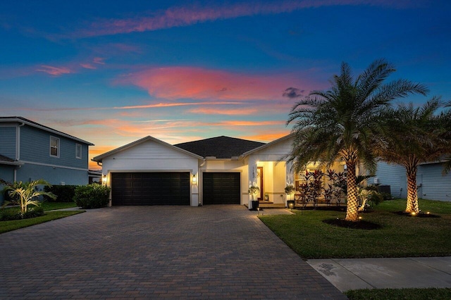 view of front of house with a yard and a garage