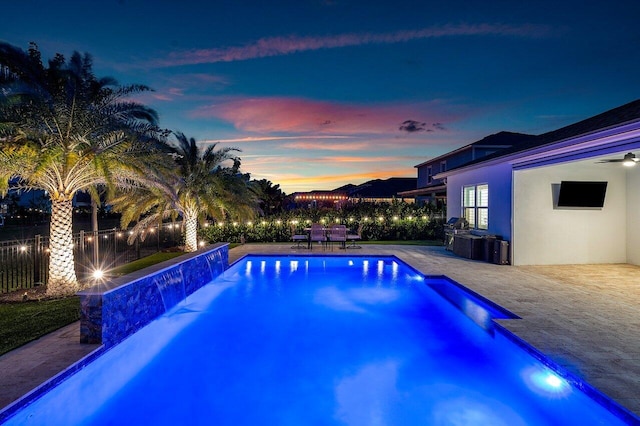 view of swimming pool featuring pool water feature and a patio