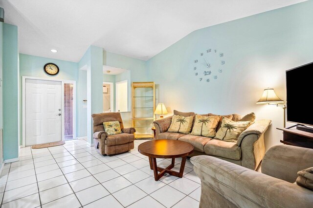 living room with light tile patterned floors and lofted ceiling