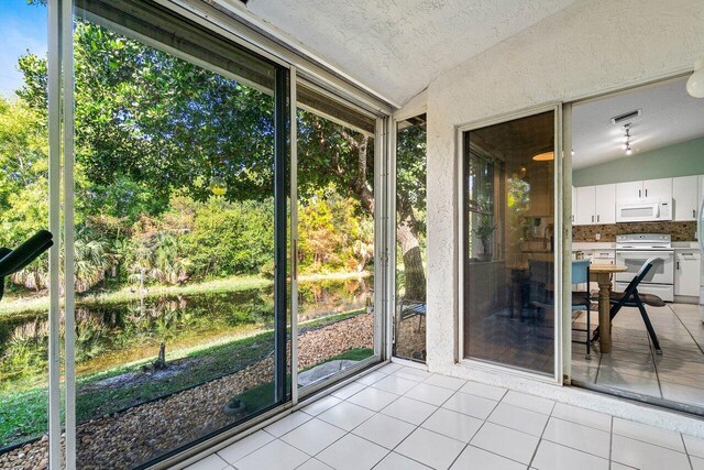 unfurnished sunroom with lofted ceiling